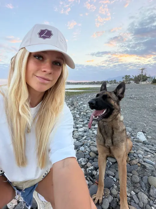 Alisa Groen in a Locus cap with Zana at dusk