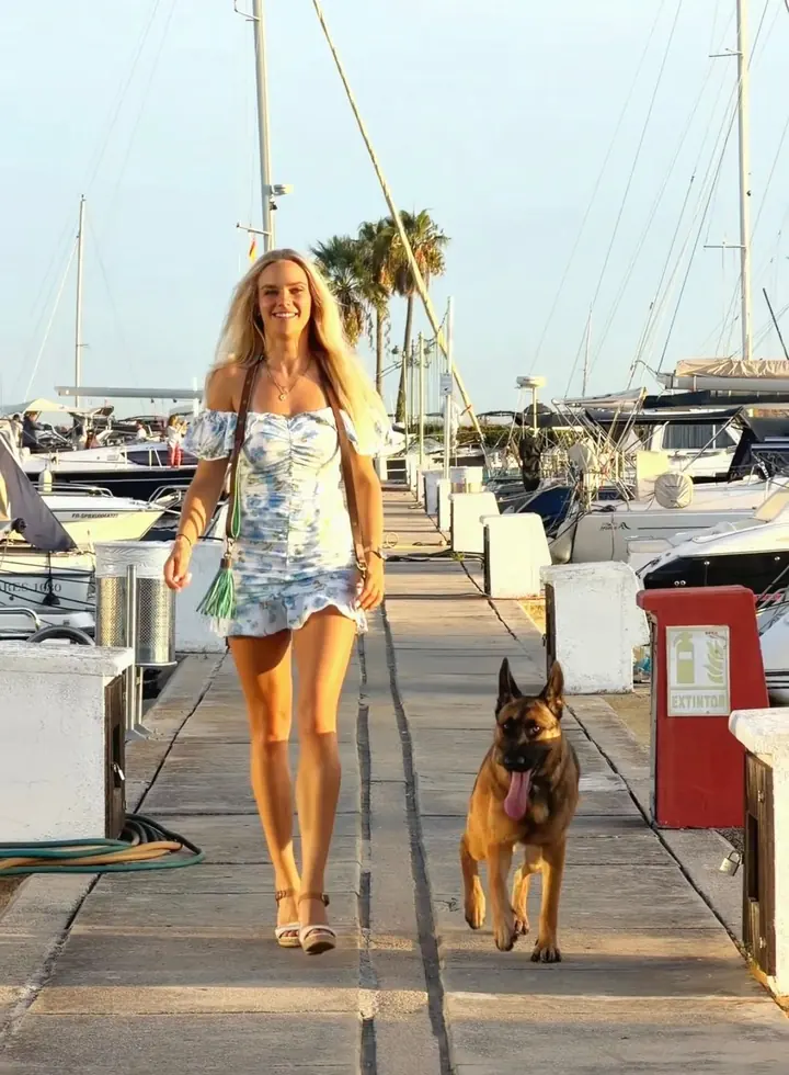 Zana walking beside Alisa along a marina pier